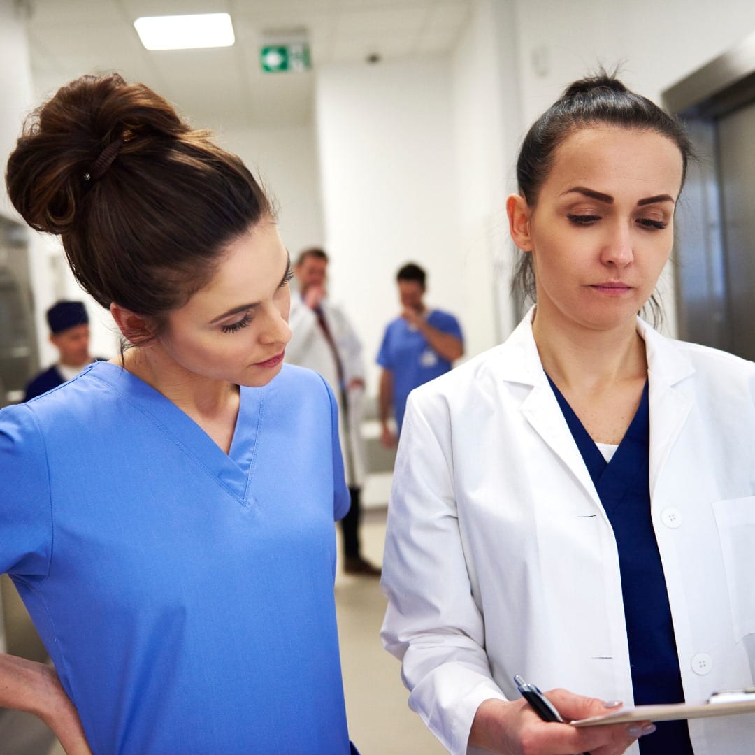 Doctor and nurse looking at a file while in a hospital