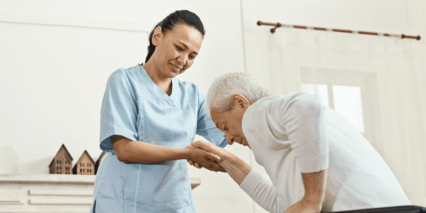 Caregiver helping elderly patient