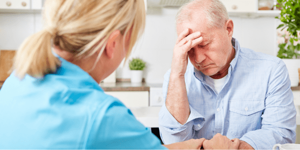 Elderly man and caring nurse