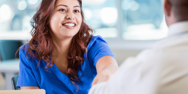 Nursing smiling and sitting down