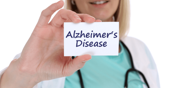 A nurse holding a card that says Alzheimer’s Disease for Alzheimer's care