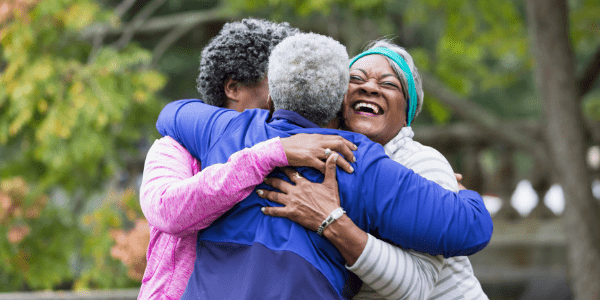 Three women hugging