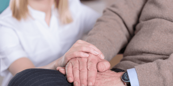 A Woman supporting an elderly man