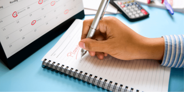 Senior care planning woman's hand writing on a notebook