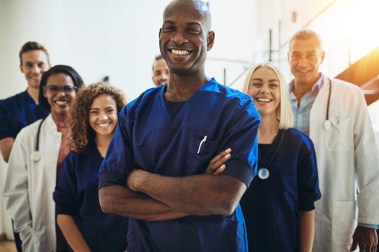 Nurse standing in a hospital with crew